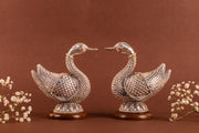 Pair of 999 pure silver swan earrings by Rasava Jewels, detailed handcrafted jewelry with sleek silver finish.